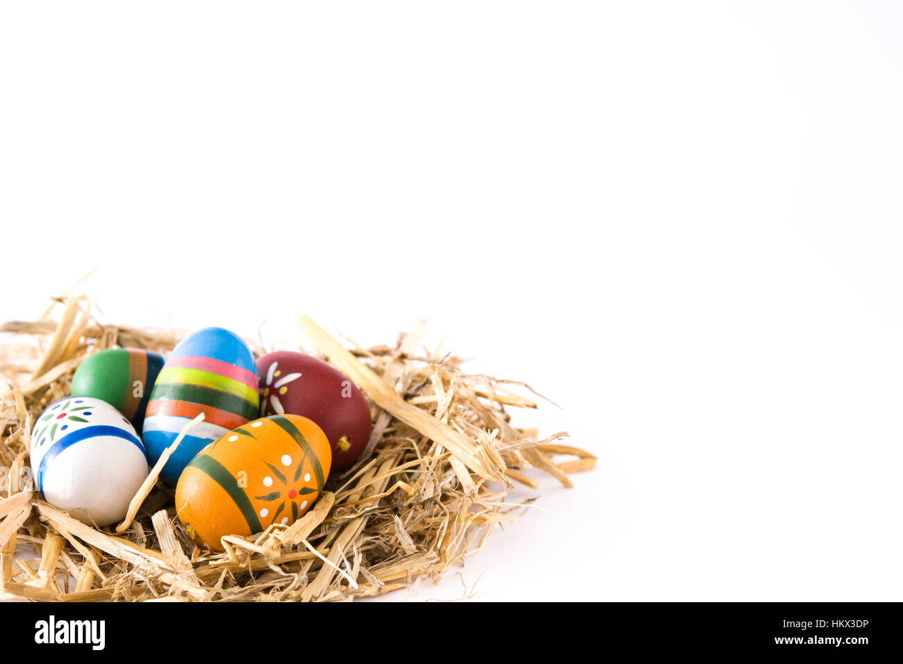 Easter eggs in a nest isolated on white background Stock Photo - Alamy