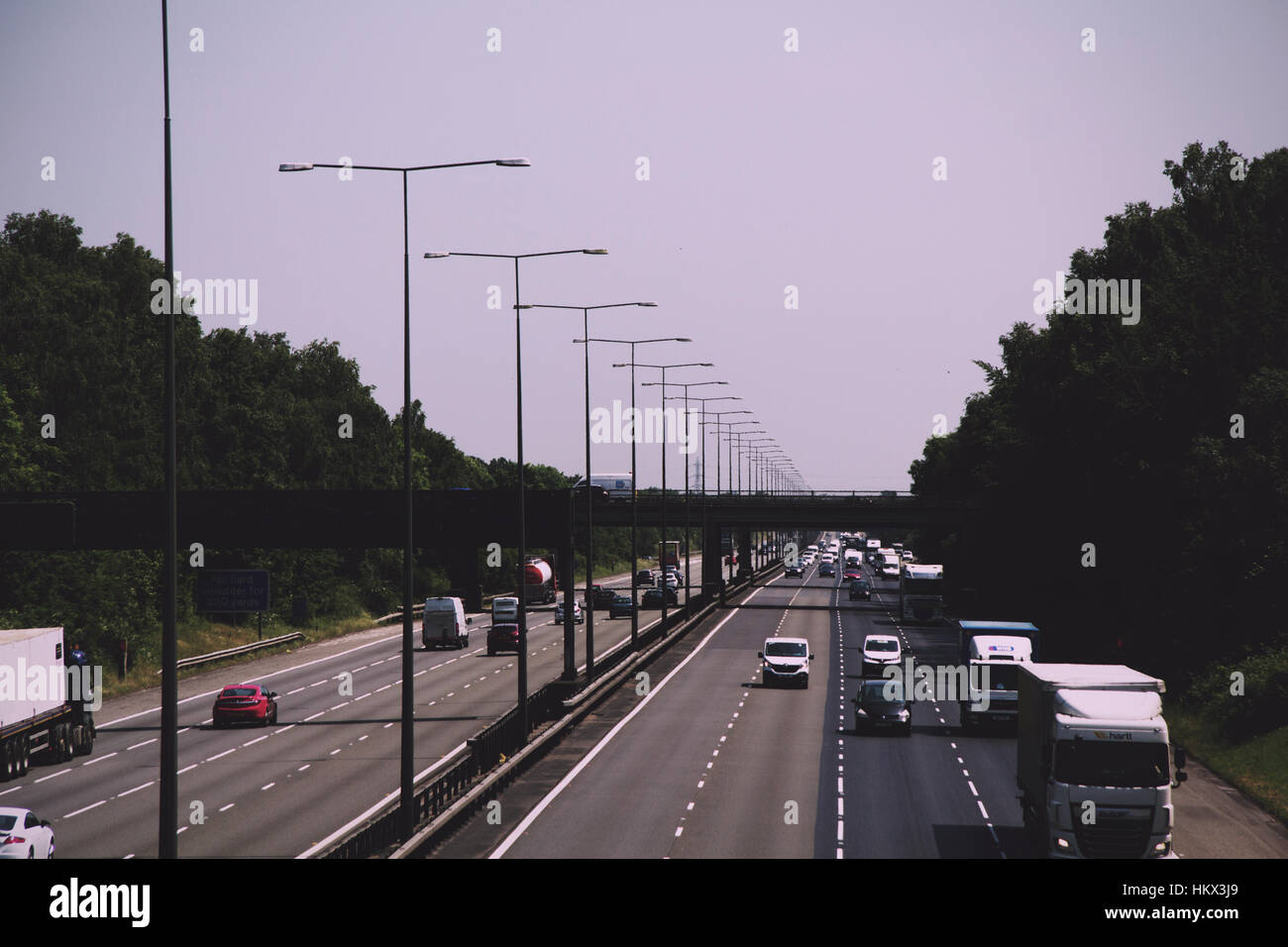 BEACONSFIELD, ENGLAND - JUNE 2016: Busy M40 motorway at the Beaconsfield turn off  Vintage Retro Filter. Stock Photo