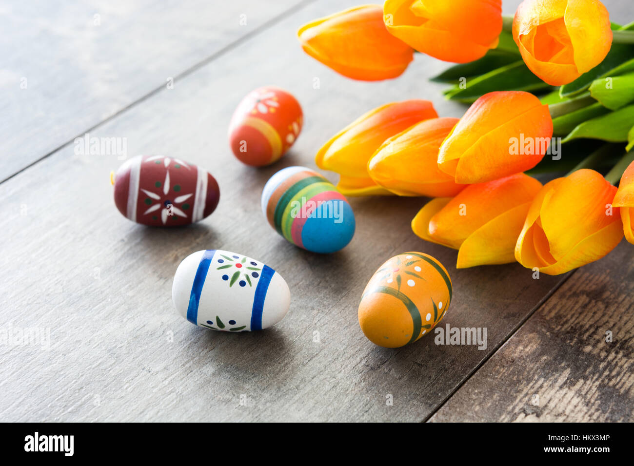 Easter eggs and tulips on wooden table Stock Photo - Alamy