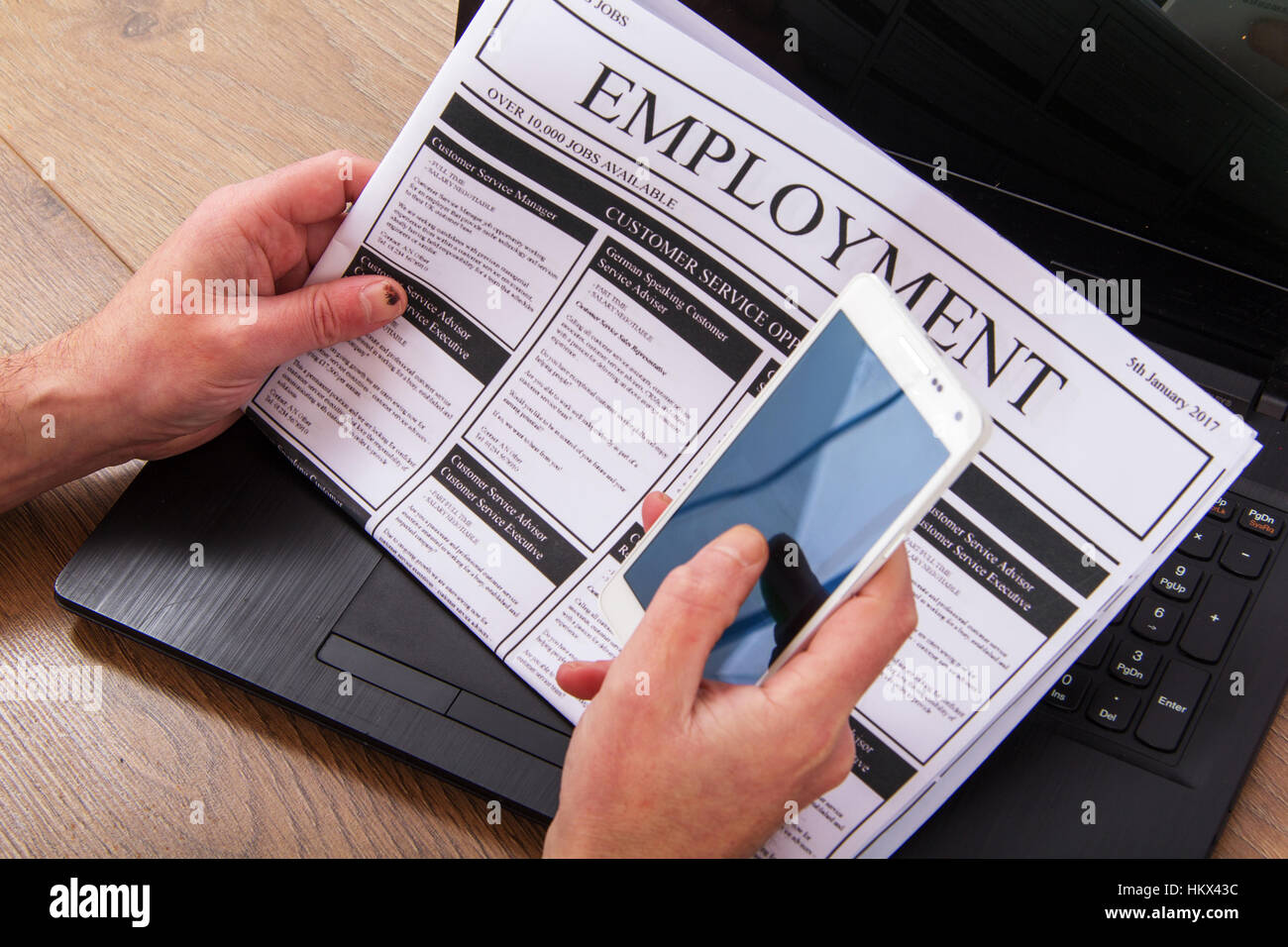 Searching for a new job or employment in a newspaper Stock Photo