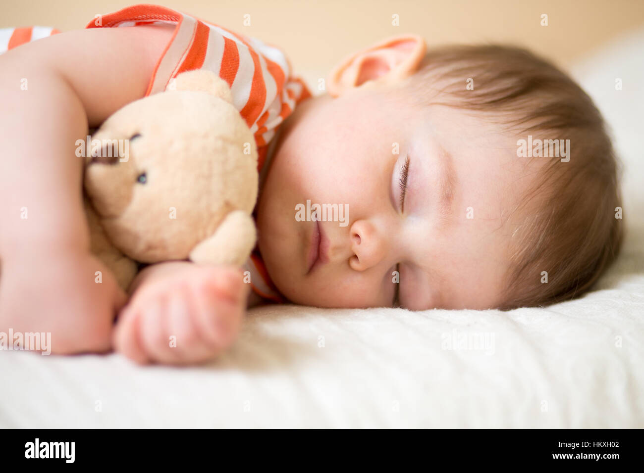 baby sleeping with teddy