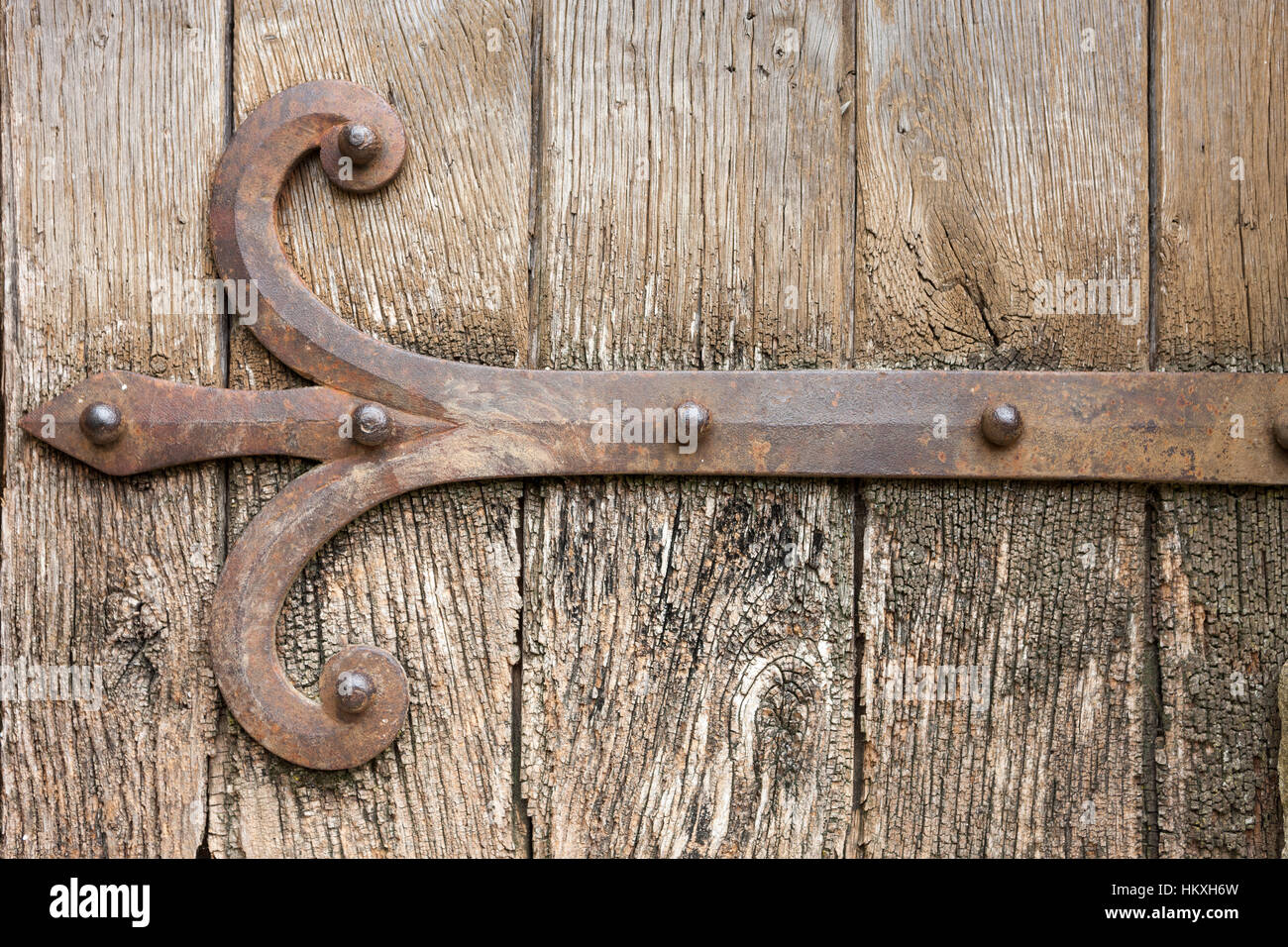 Detail of old wooden door with cast iron door brace Stock Photo Alamy