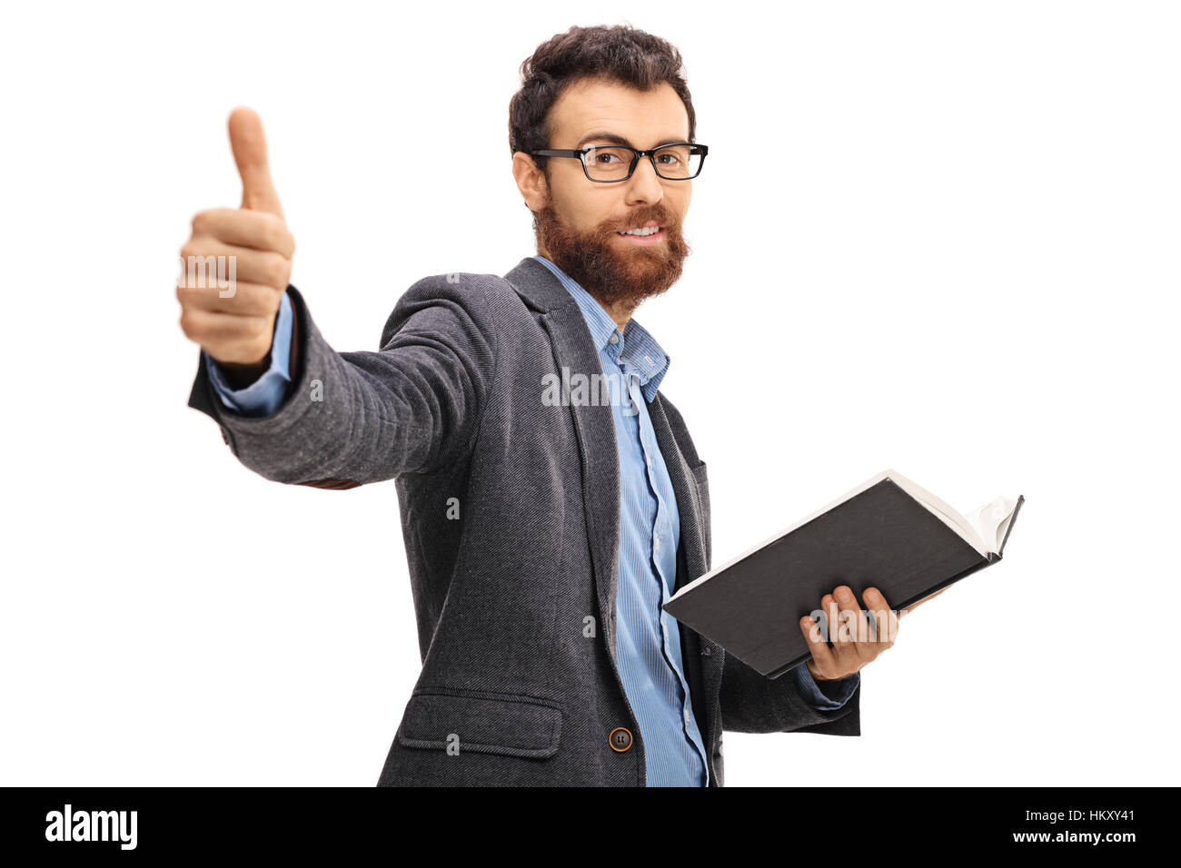 Bearded man giving a thumb up and holding a book isolated on white ...