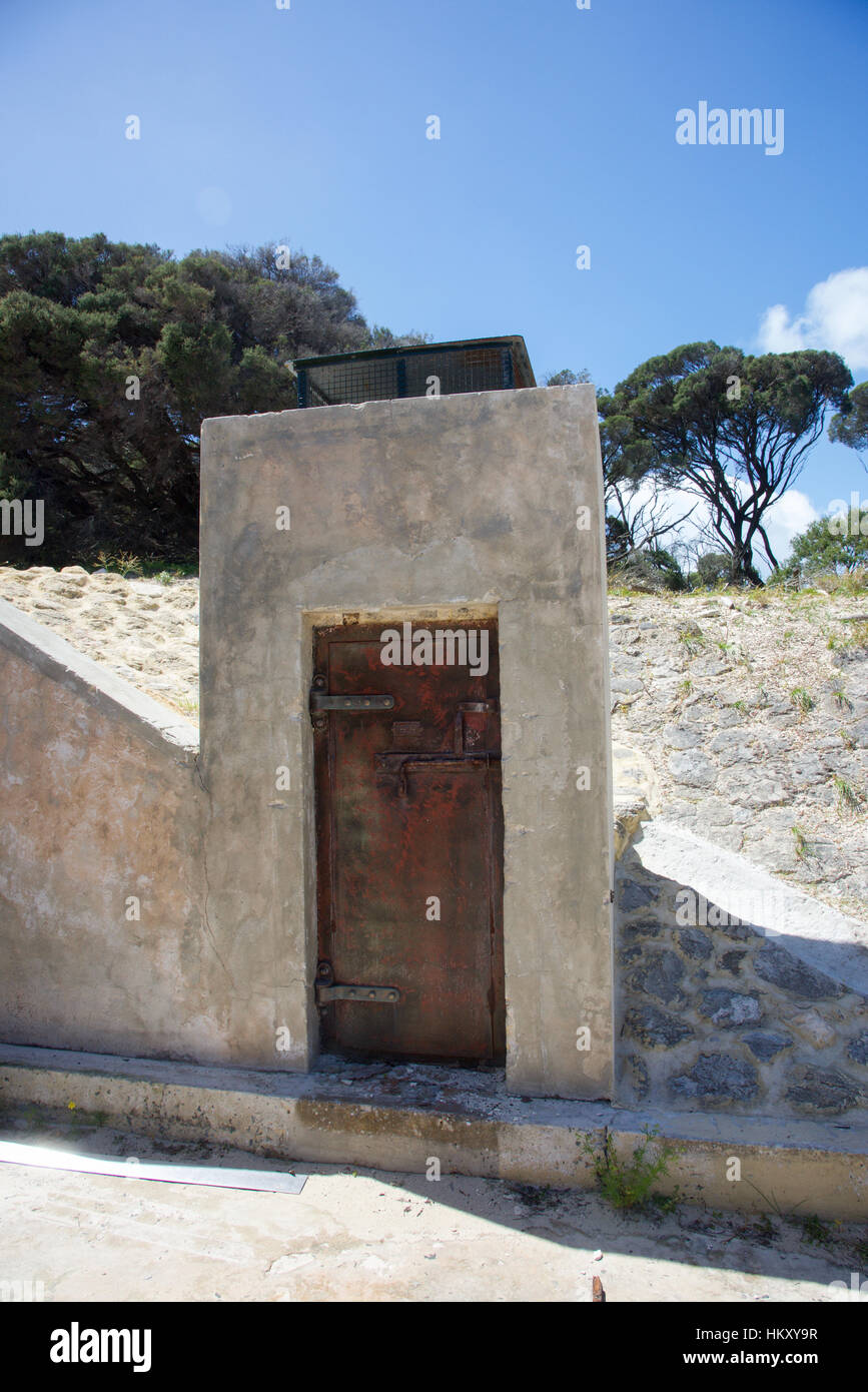 Wooden doorway with concrete exterior at the WWII military installation at Bickley Point at Oliver Hill at Rottnest Island in Western Australia. Stock Photo