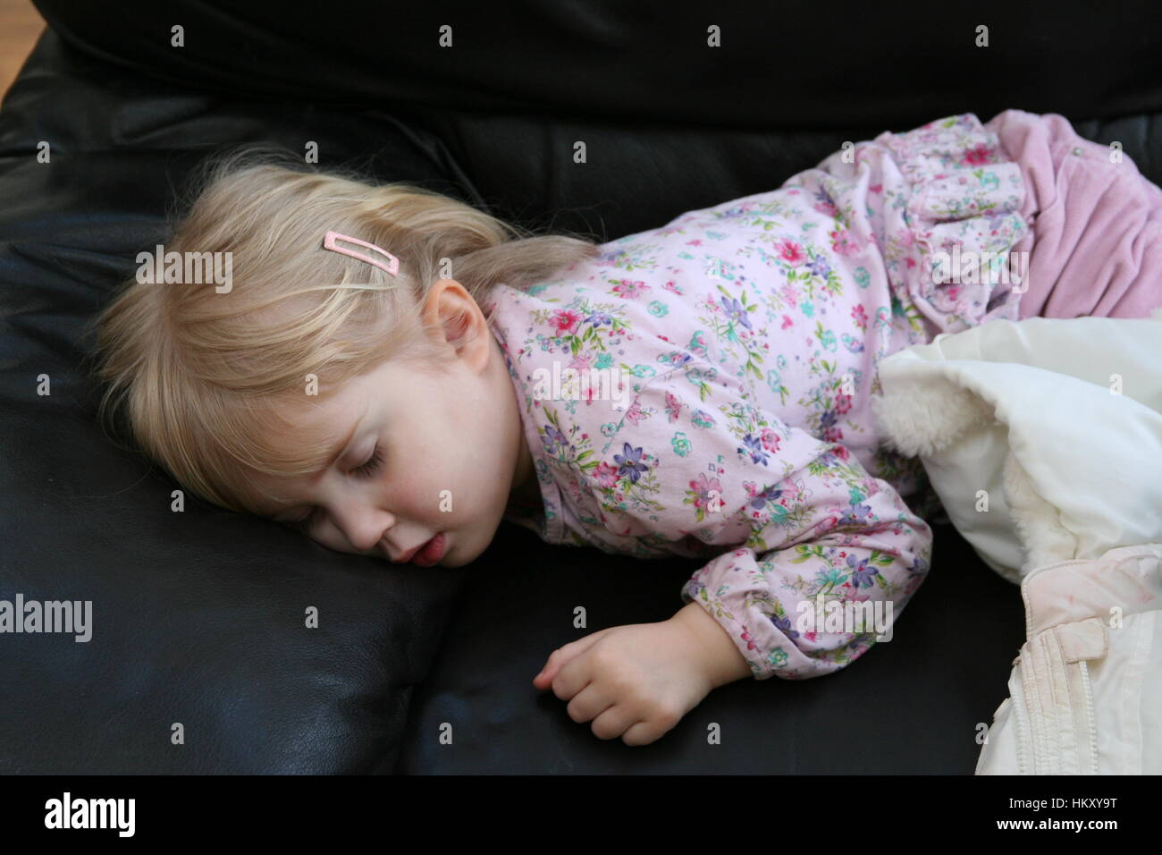 Sleeping toddler asleep in her clothes, sleeping on her tummy, exhausted concept, fast asleep, wrecked, long day concept tired concept Stock Photo