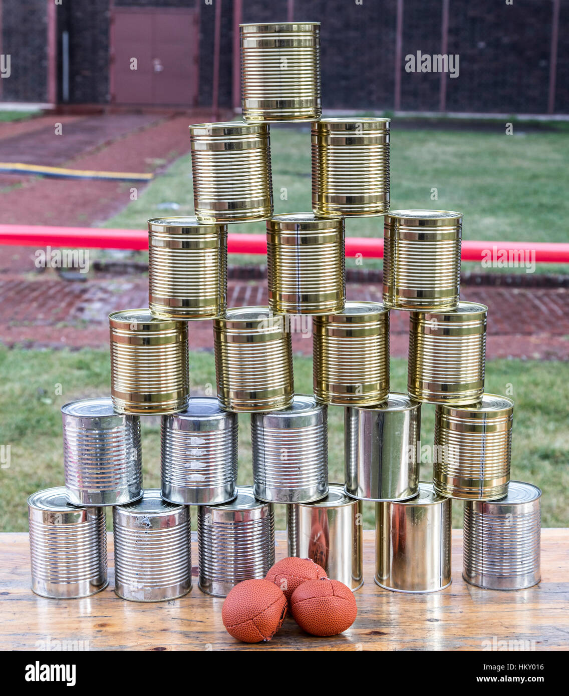 Cans, empty tin cans, built to a pyramid, at a children's party, throwing balls, Stock Photo