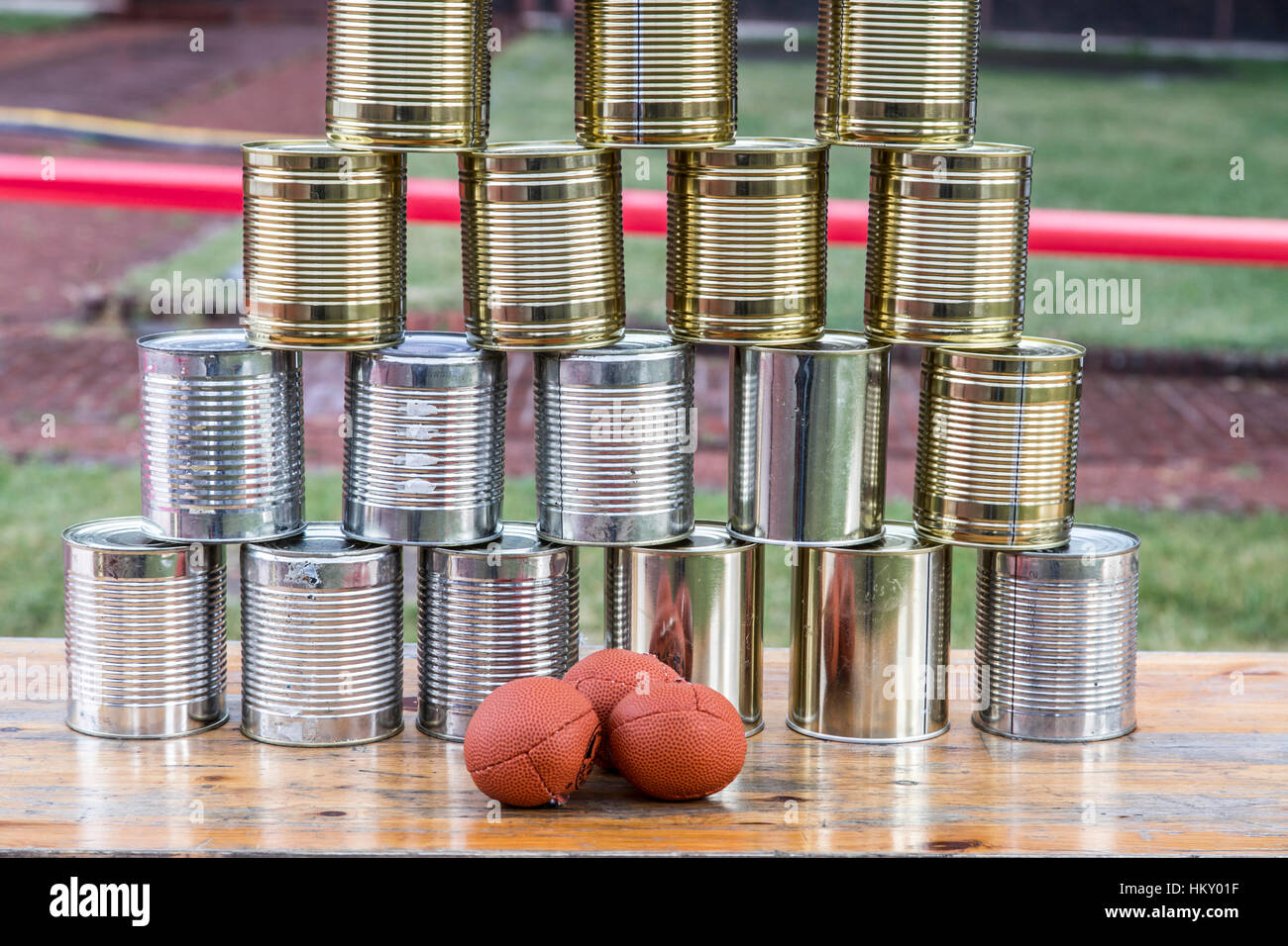 Cans, empty tin cans, built to a pyramid, at a children's party, throwing balls, Stock Photo