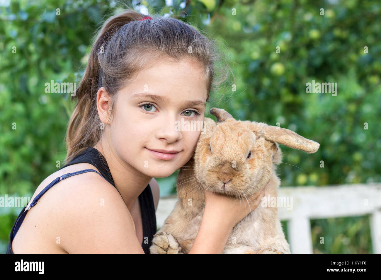 A girl holds a rabbit Stock Photo