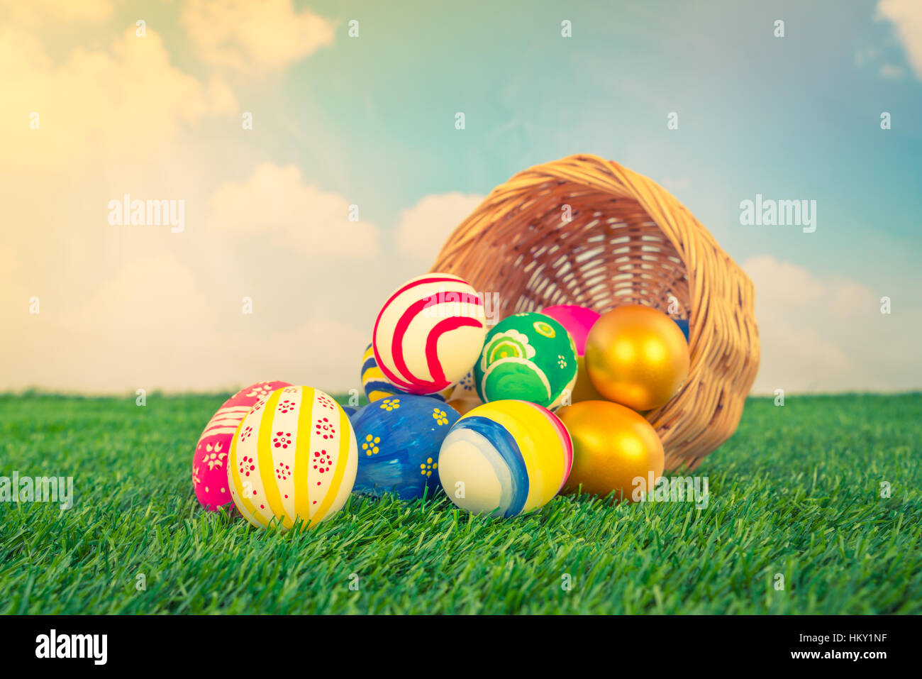 Easter Eggs on Fresh Green Grass over blue sky ( Filtered image ...