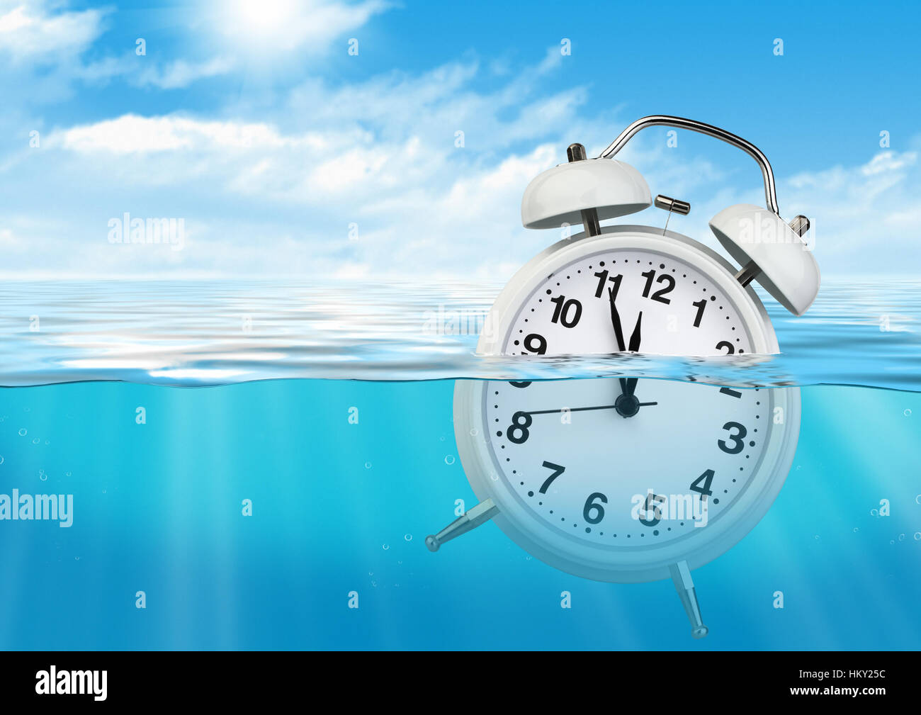 Clock in water, waste of time concept Stock Photo