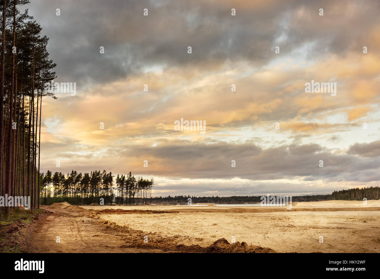 Sand quarry with blue lake under the magnificient sky. Stock Photo