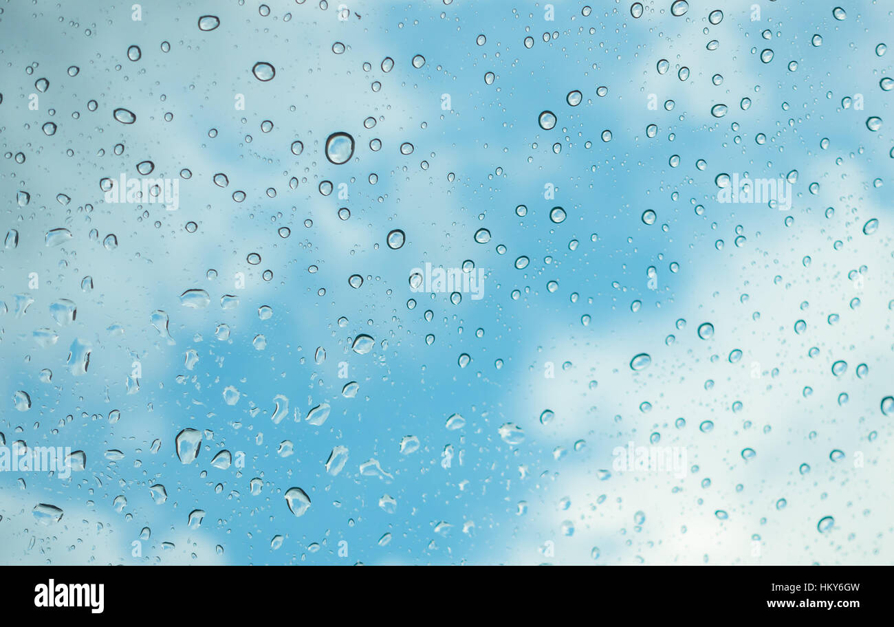 Drops of water on glass window over blue sky Stock Photo - Alamy