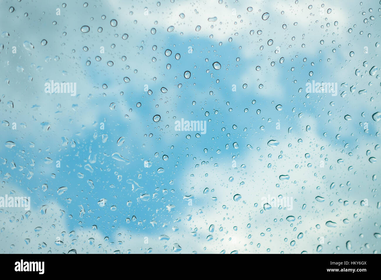 Drops of water on glass window over blue sky Stock Photo - Alamy