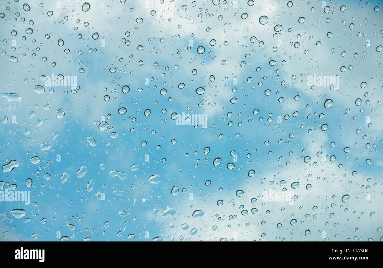 Drops of water on glass window over blue sky Stock Photo - Alamy