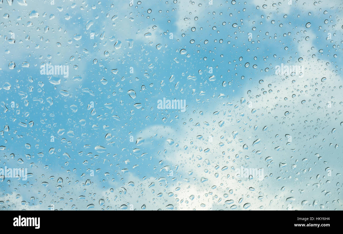 Drops of water on glass window over blue sky Stock Photo - Alamy