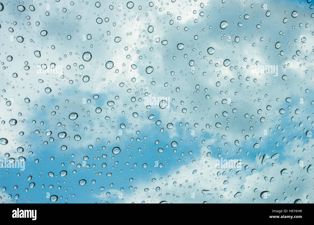 Drops of water on glass window over blue sky Stock Photo - Alamy