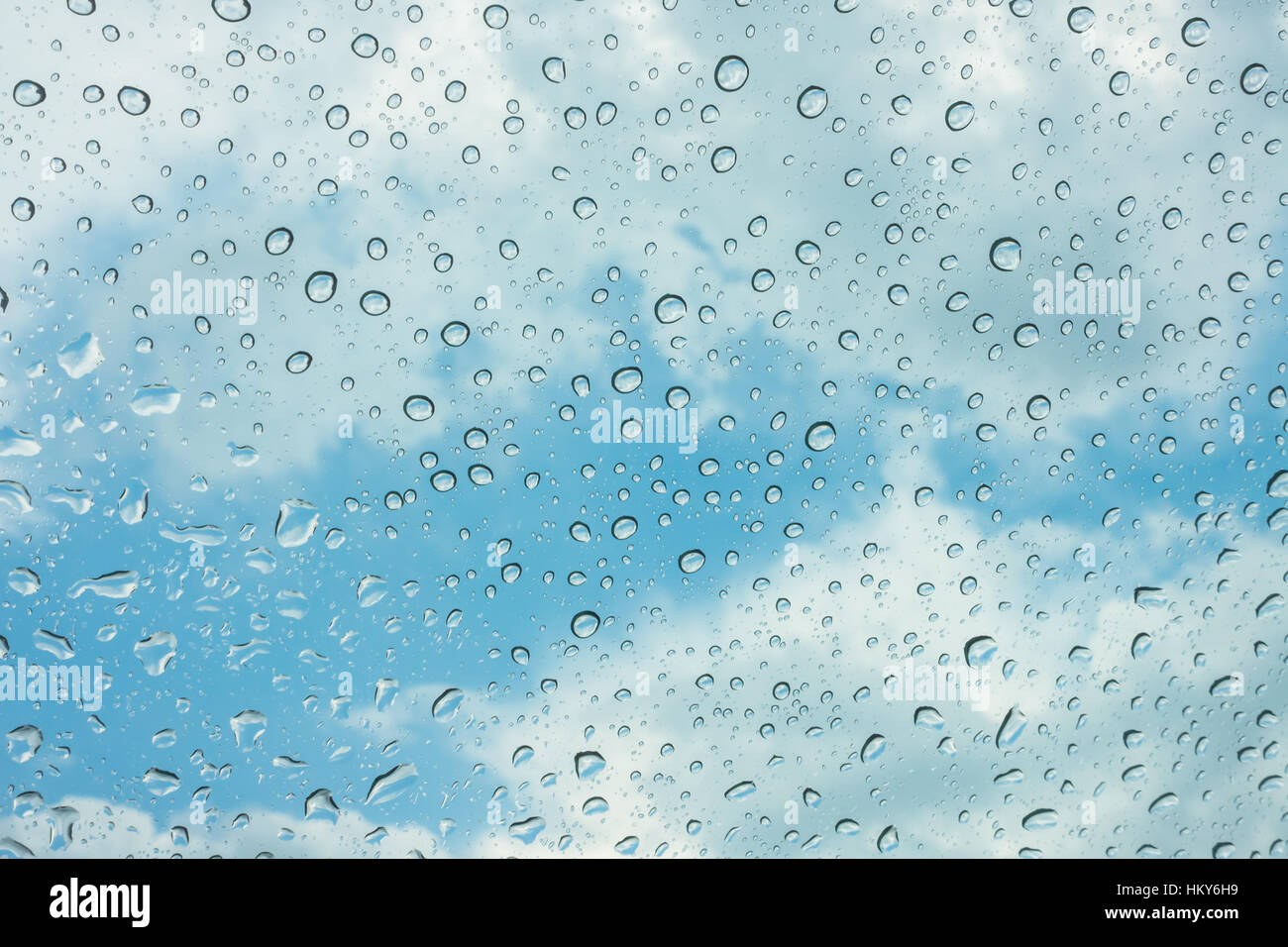 Drops of water on glass window over blue sky Stock Photo - Alamy