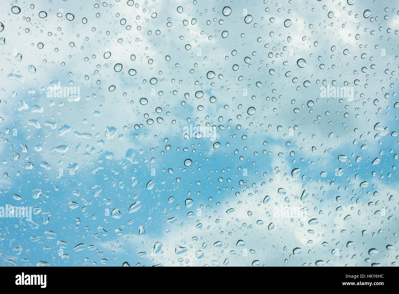 Drops of water on glass window over blue sky Stock Photo - Alamy