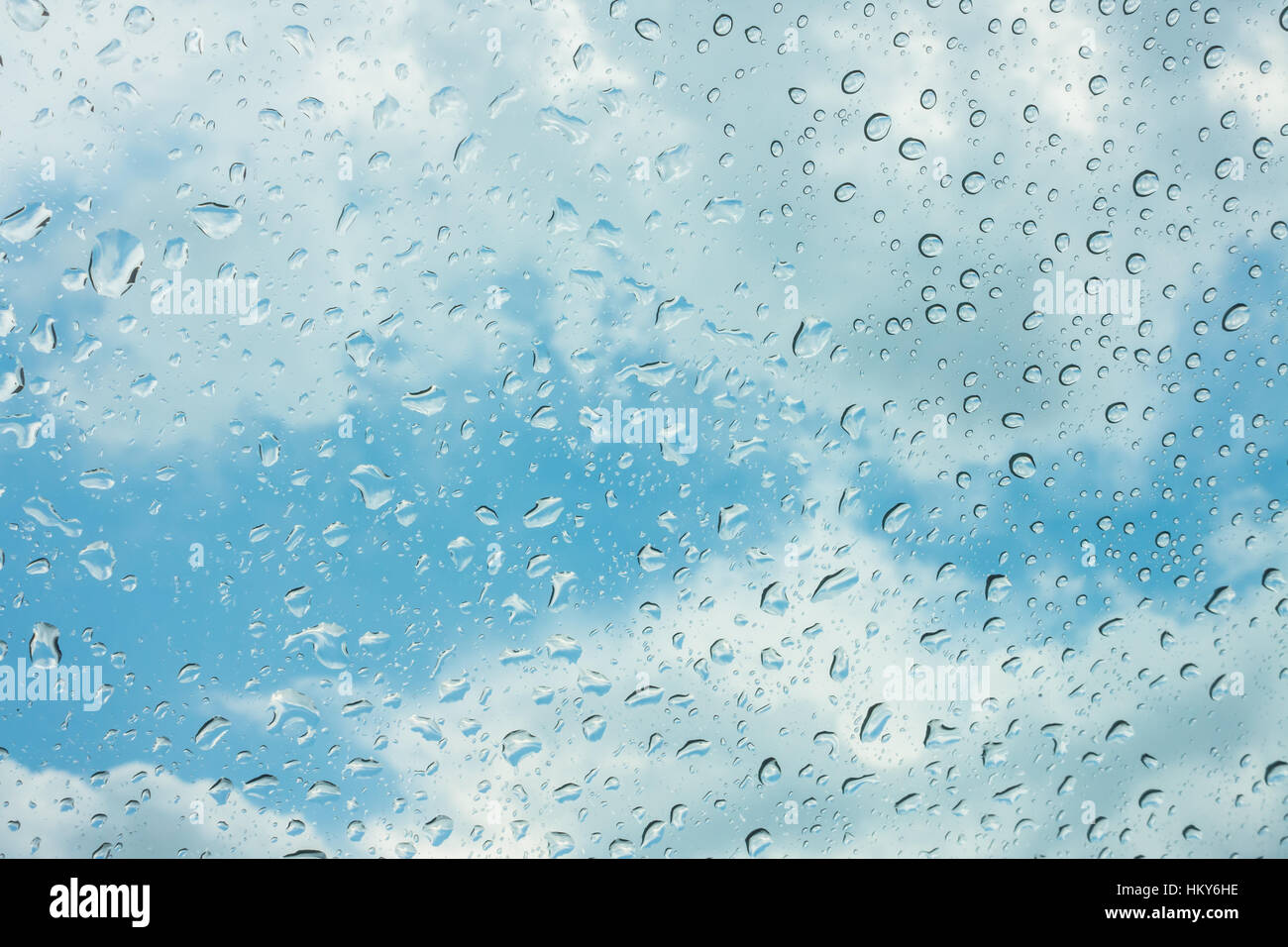 Drops of water on glass window over blue sky Stock Photo - Alamy