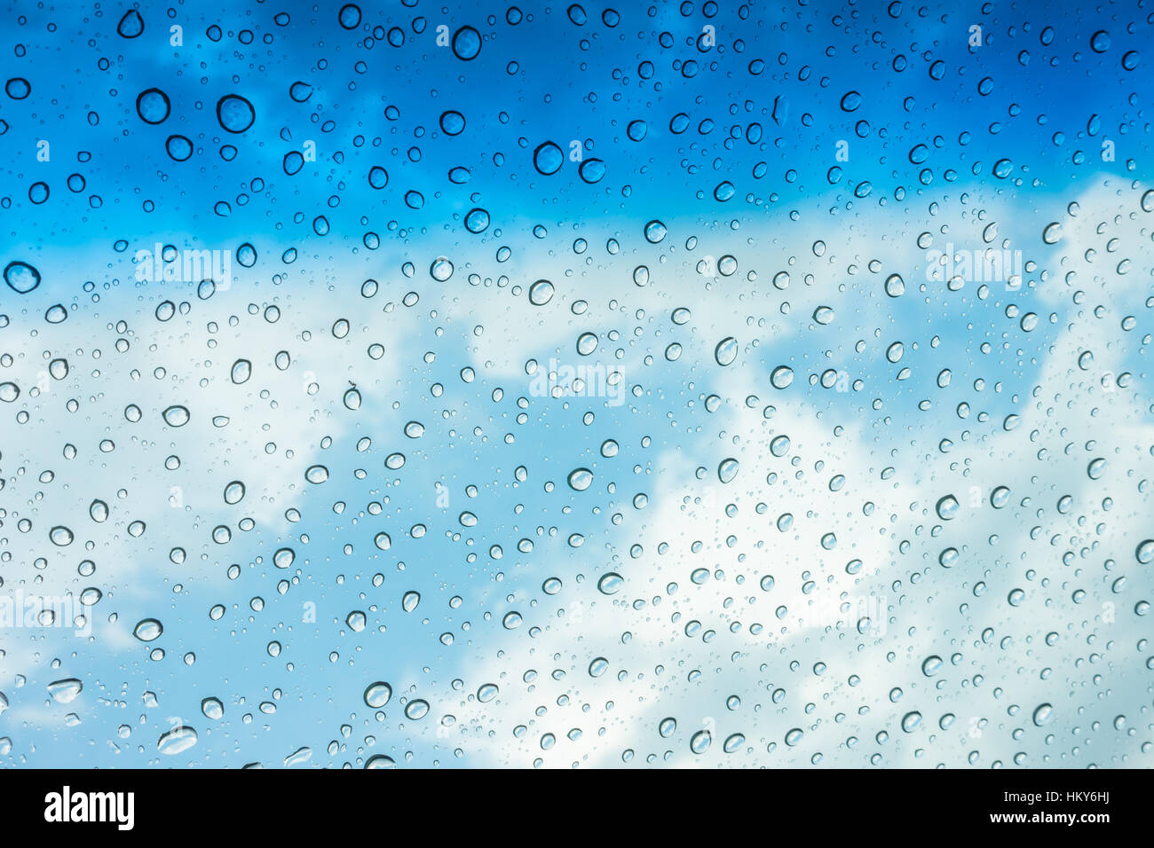 Drops of water on glass window over blue sky Stock Photo - Alamy