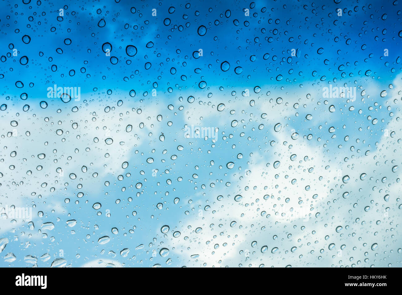 Drops of water on glass window over blue sky Stock Photo - Alamy