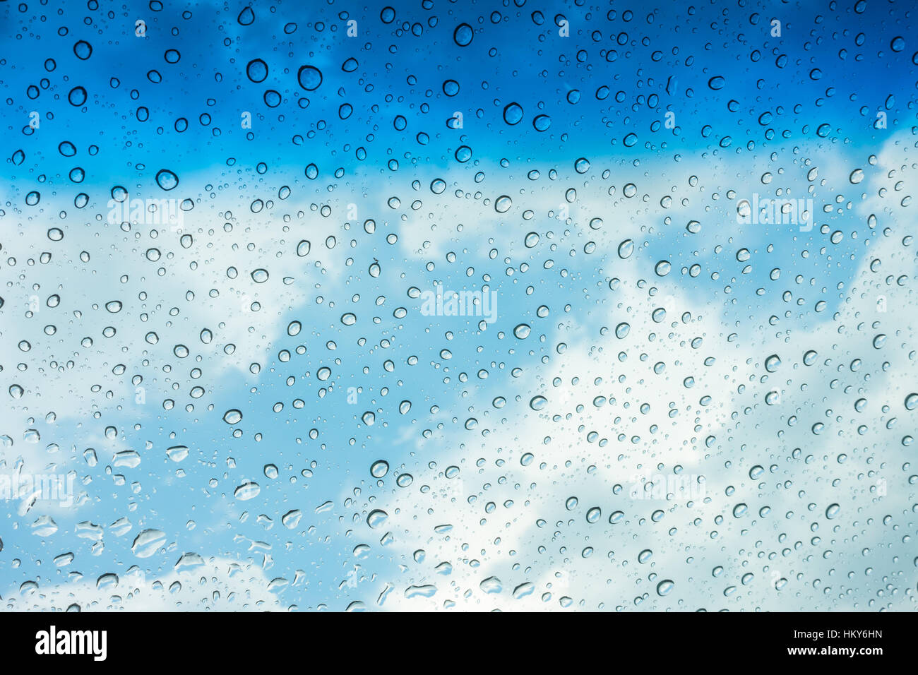 Drops of water on glass window over blue sky Stock Photo - Alamy
