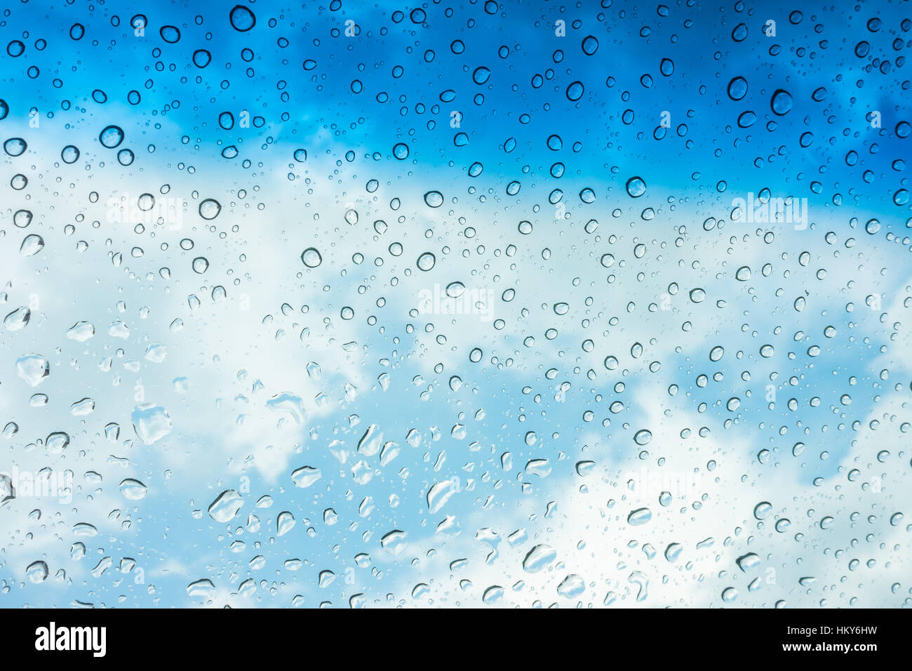Drops of water on glass window over blue sky Stock Photo - Alamy