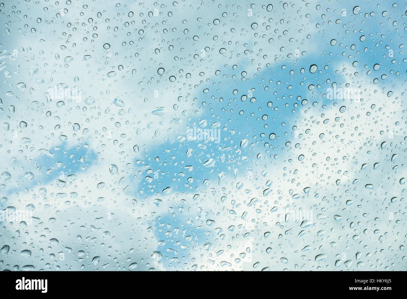 Drops of water on glass window over blue sky Stock Photo - Alamy