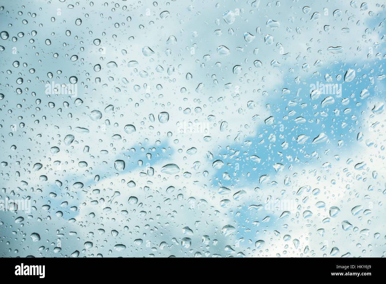 Drops of water on glass window over blue sky Stock Photo - Alamy