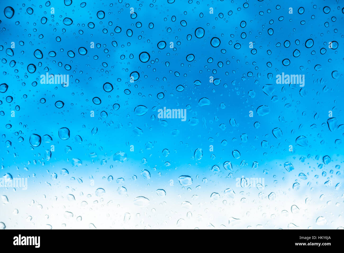Drops of water on glass window over blue sky Stock Photo - Alamy