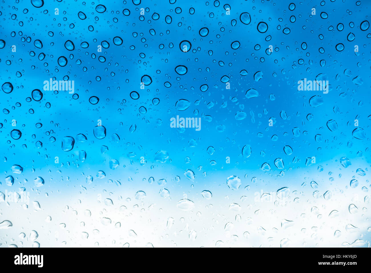 Drops of water on glass window over blue sky Stock Photo - Alamy