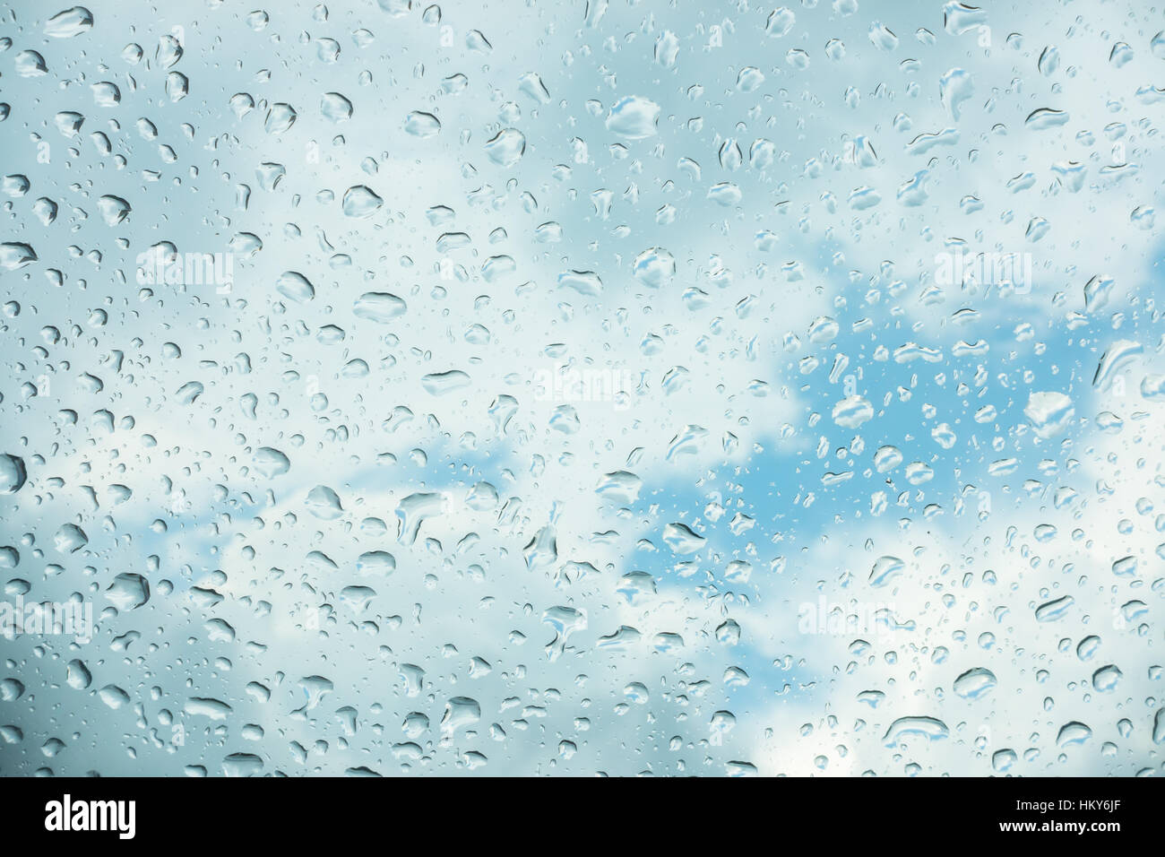 Drops of water on glass window over blue sky Stock Photo - Alamy
