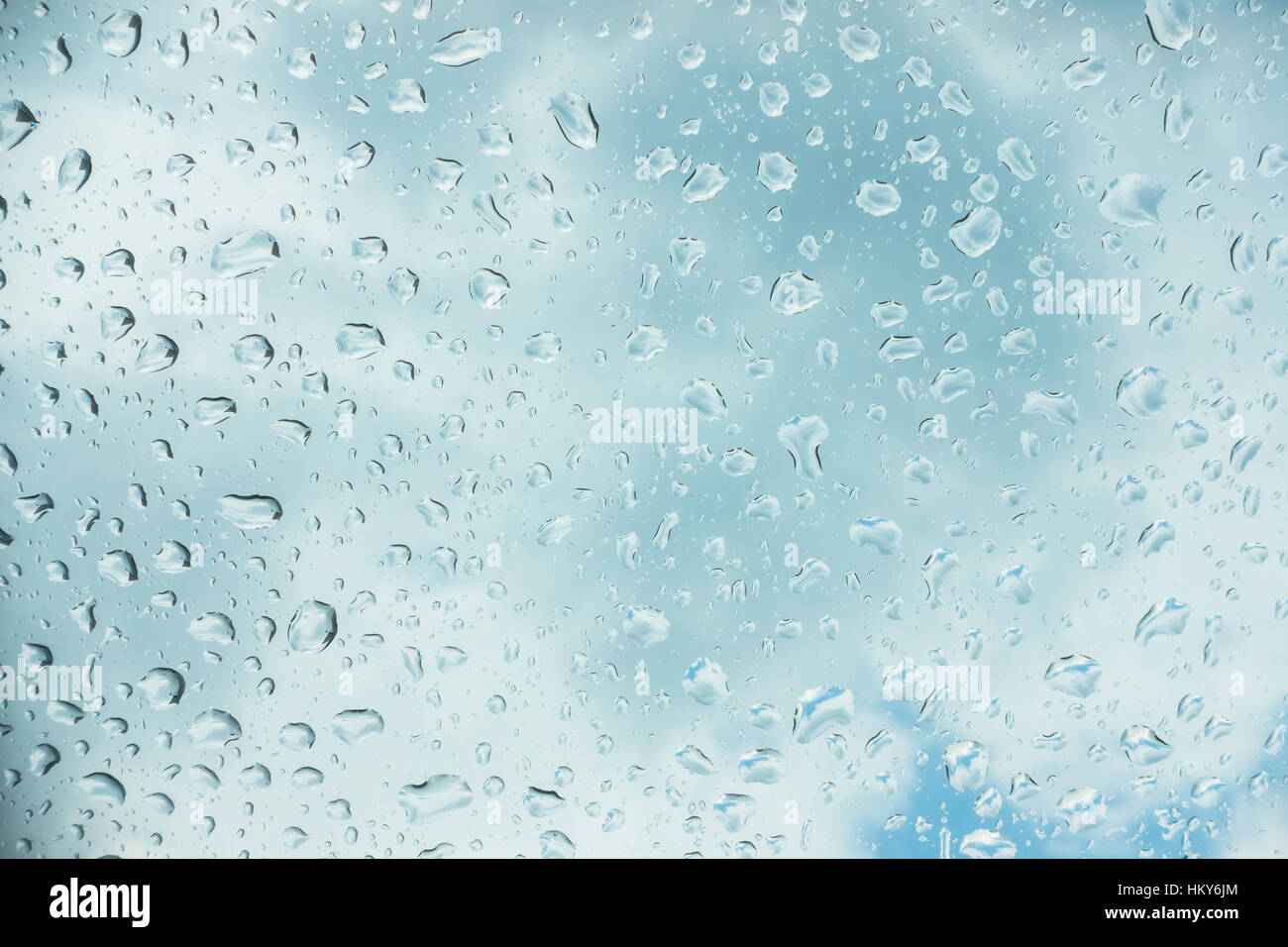 Drops of water on glass window over blue sky Stock Photo - Alamy