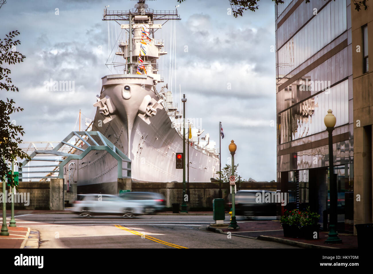 The intersection of Boush and West Plume streets in Norfolk, Virginia with the USS Wisconsin in the background. Stock Photo