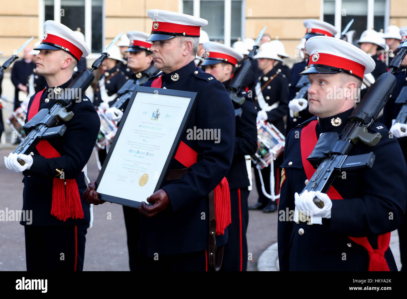 Warrant officer 2 Buzz Burrell RMR holds the certificate listing the ...