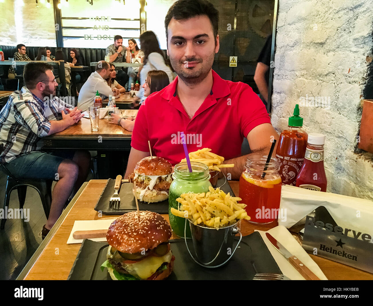 BUCHAREST, ROMANIA JUNE 09, 2016 People Eating Burgers, French Fries