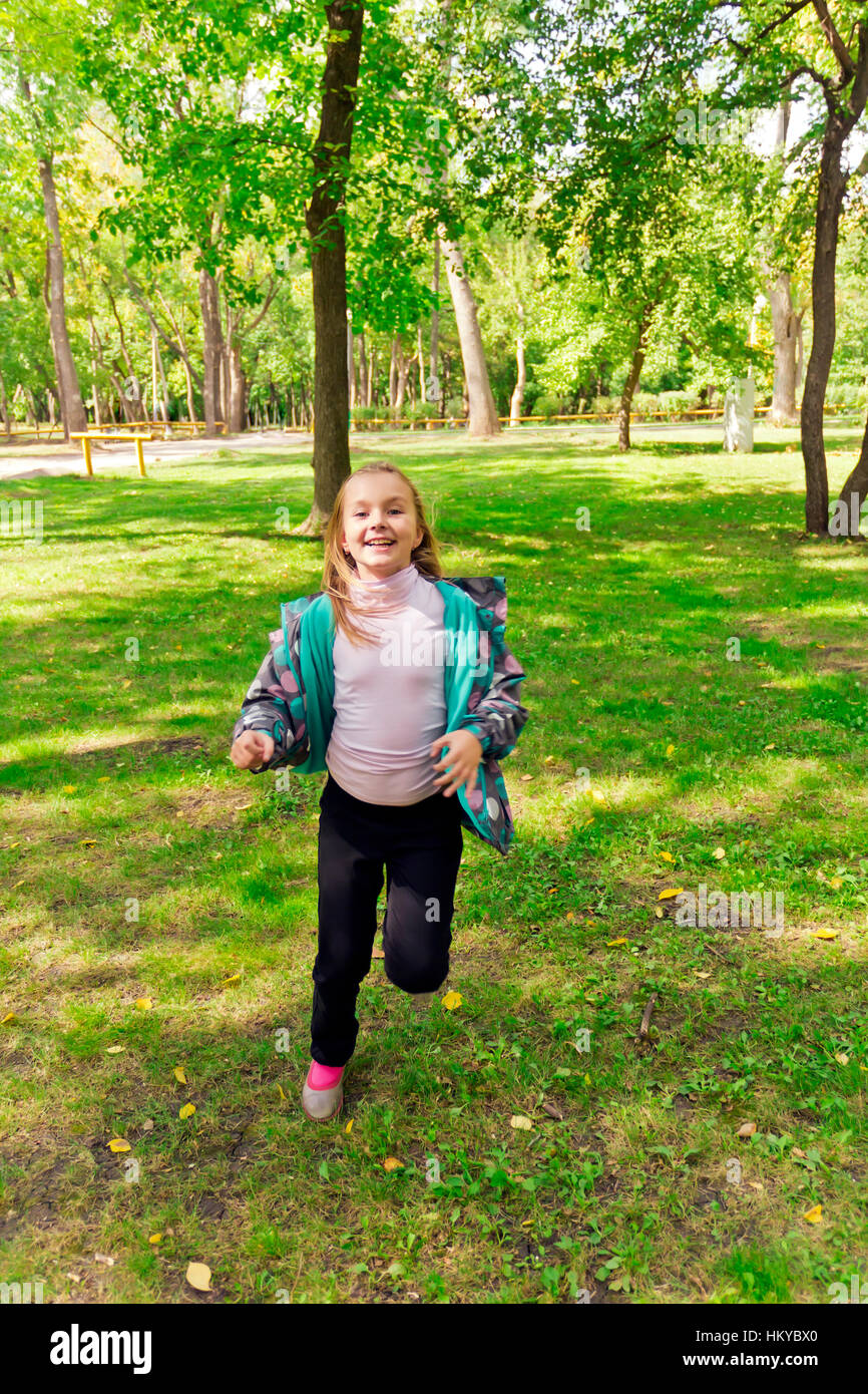 Photo of cute running girl in summer Stock Photo