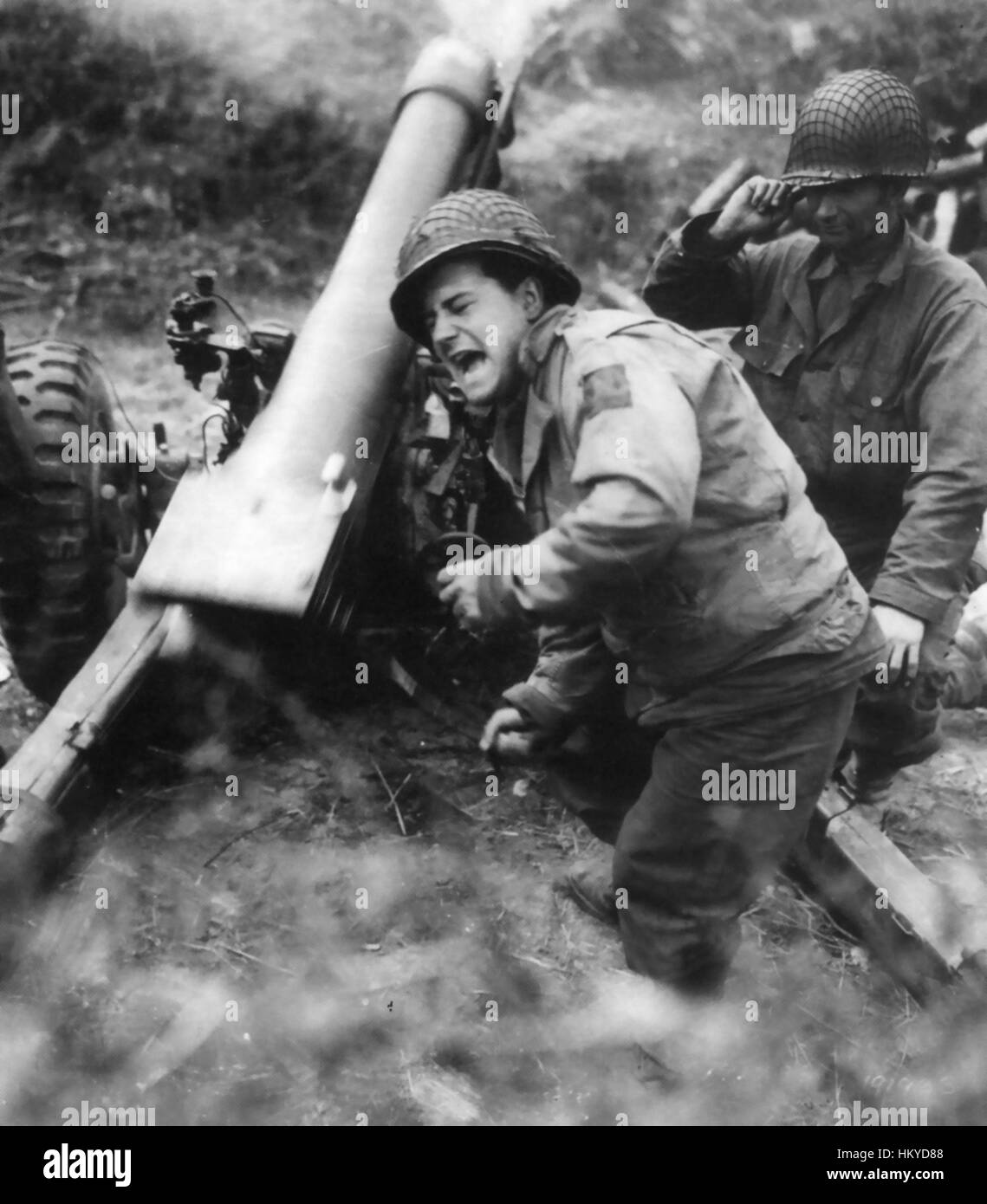NORMANDY INVASION.  An American M2 Howitzer gun crew fire their weapon in the Carentan Peninsula on 11 June 1944.  Photo: US Official Stock Photo