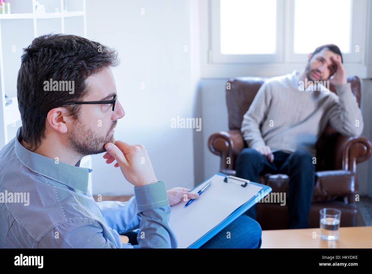 Psychologist taking notes during psychotherapy session Stock Photo