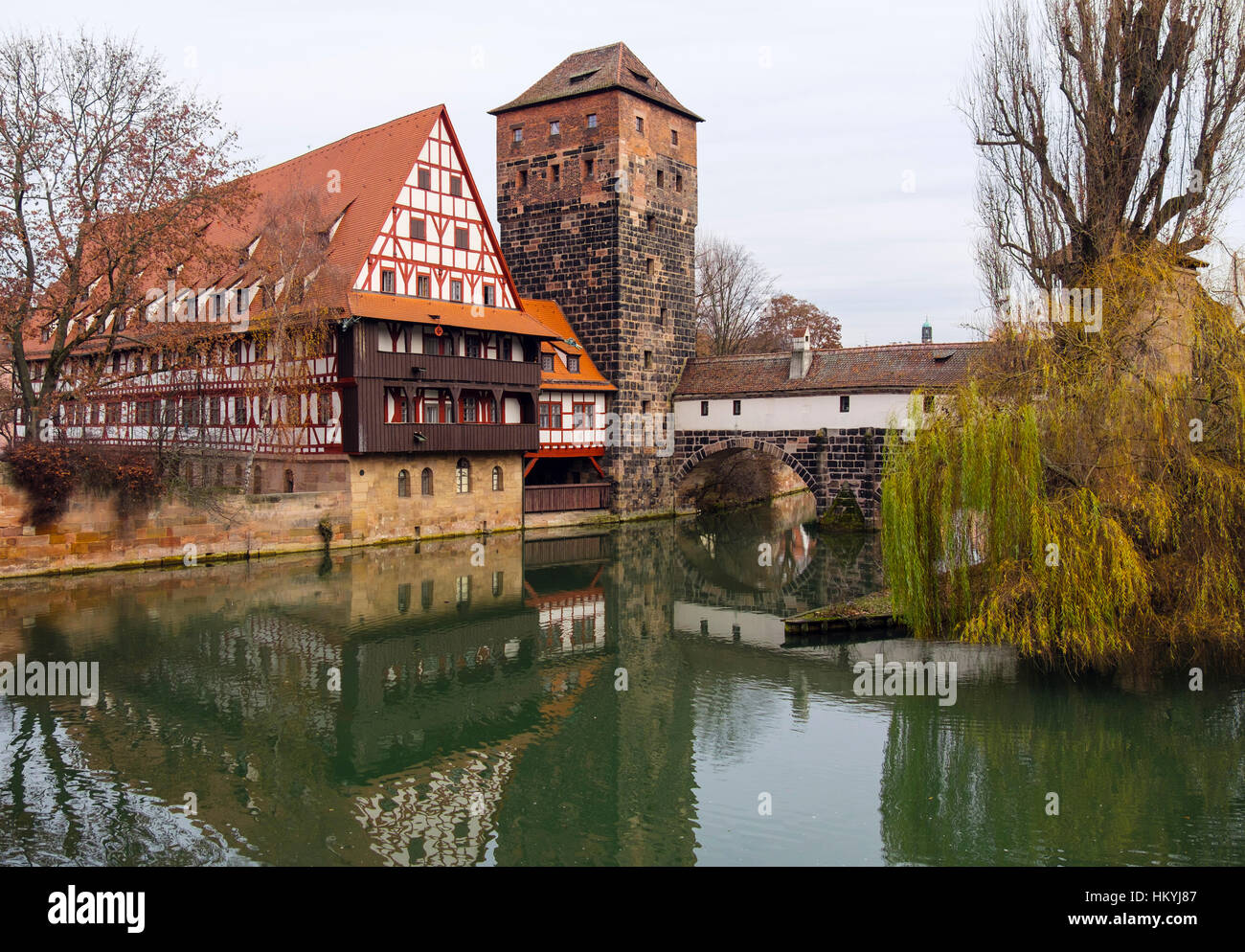 15thc Weinstadle timbered building now student's hall of residence and Henkersteg or Hangman's Bridge over Pegnitz River. Nuremberg, Bavaria, Germany Stock Photo