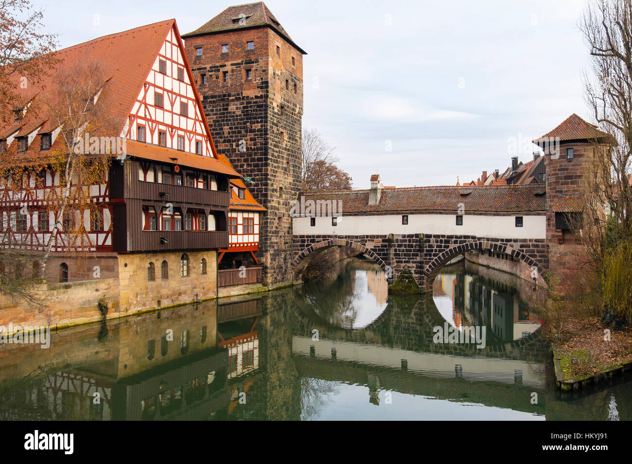 15th century Weinstadle timbered building and Henkersteg or Hangman's Bridge reflected in Pegnitz River.  Nuremberg, Bavaria, Germany, Europe Stock Photo