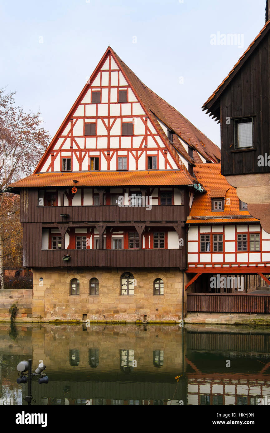 15th century Weinstadle timbered building beside Pegnitz River is now a student's University Hall of Residence.  Nuremberg, Bavaria, Germany, Europe Stock Photo