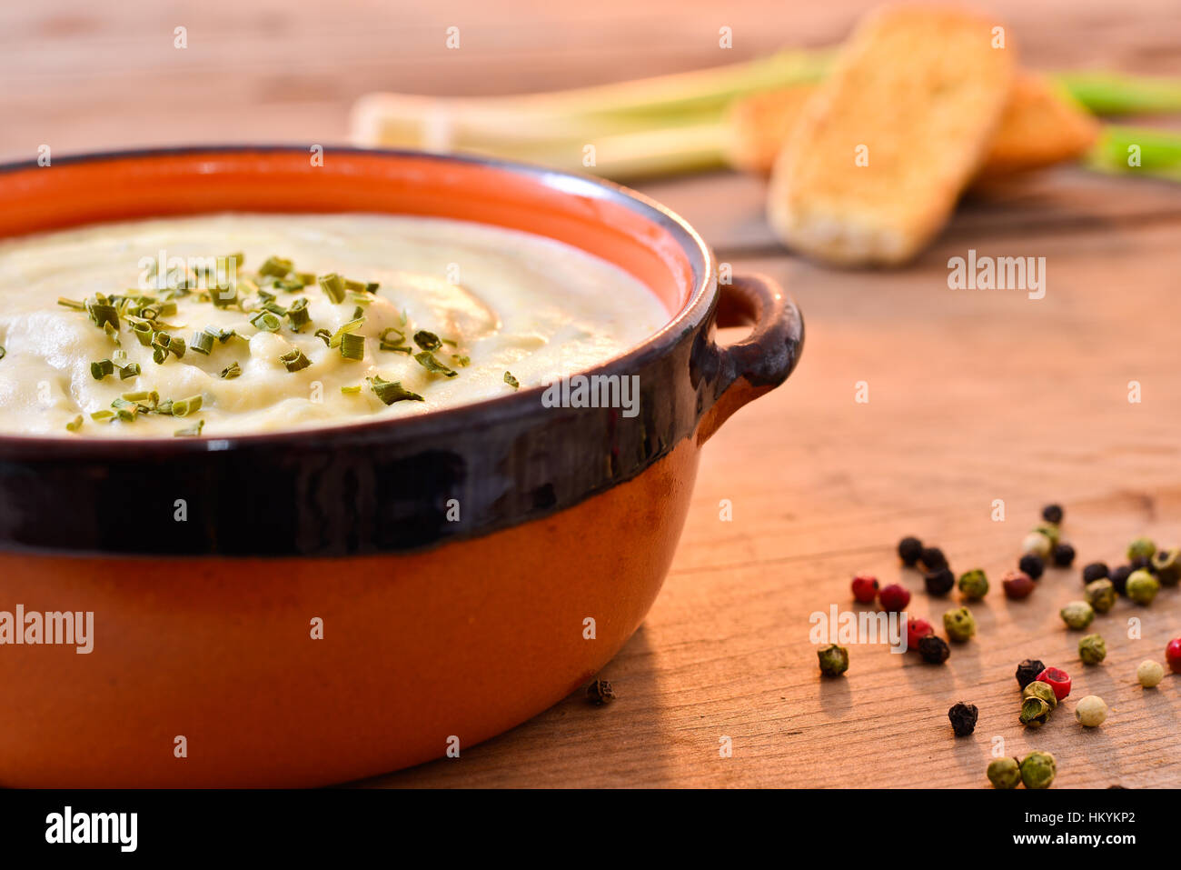 cream of broccoli and leek with toasted bread in a ceramic bowl Stock Photo
