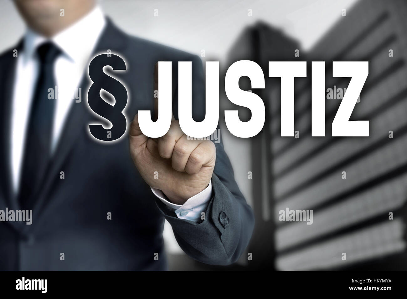 Justiz (in german Justice) is shown by businessman. Stock Photo