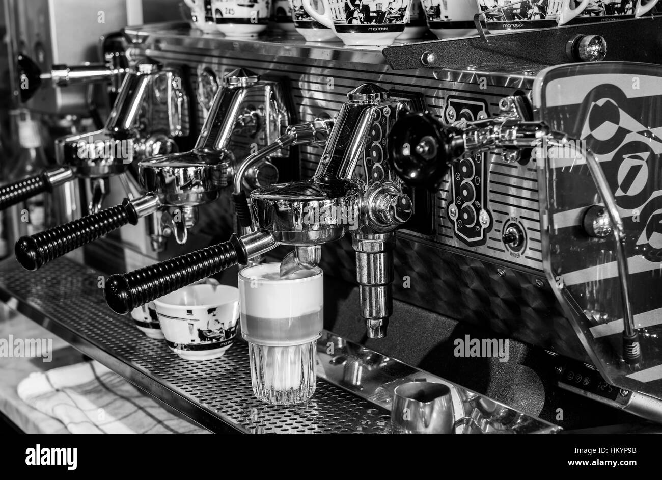 Houten, The Netherlands - August 26, 2016: Making coffee on a professional coffee machine for cappuccino and espresso. Stock Photo