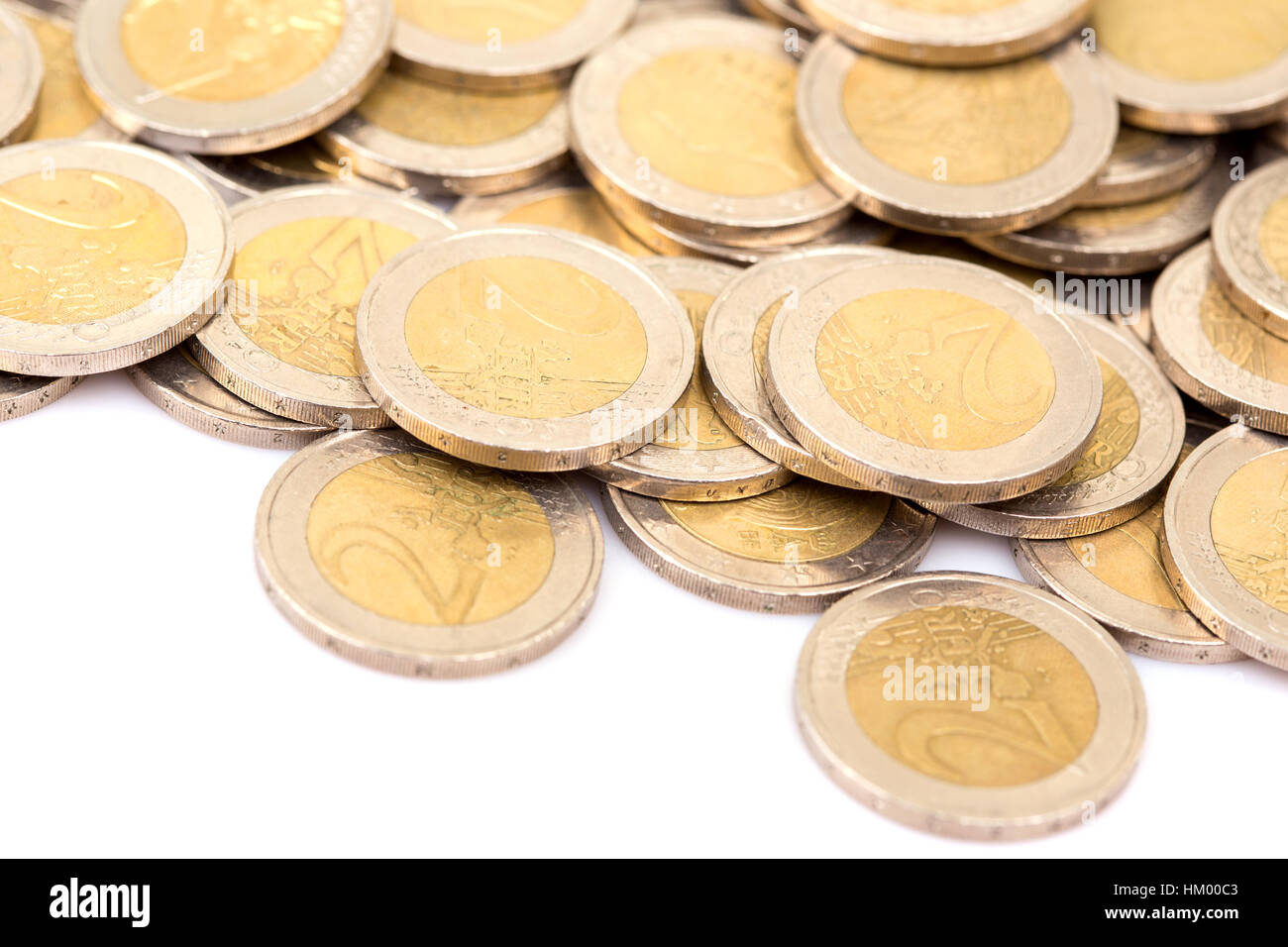 Heap of two euro coins isolated on white background Stock Photo - Alamy