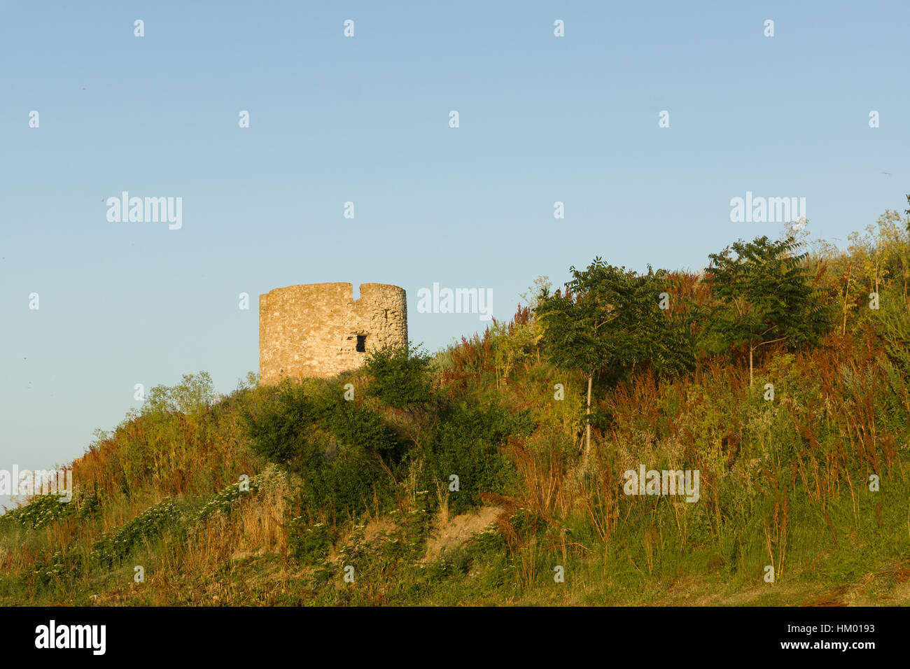 brick watchtower rises above the overgrown hill Stock Photo - Alamy