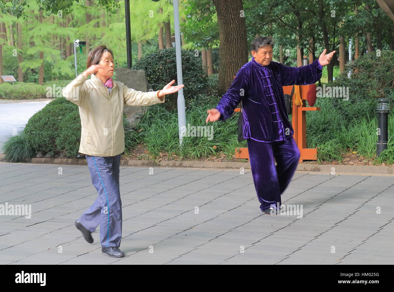 People practice Tai Chi at People’s Park in Shanghai China. Stock Photo