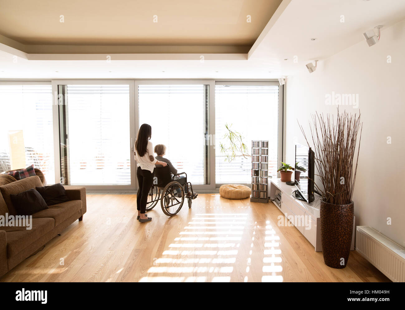 Disabled senior woman in wheelchair with her young daugher Stock Photo ...