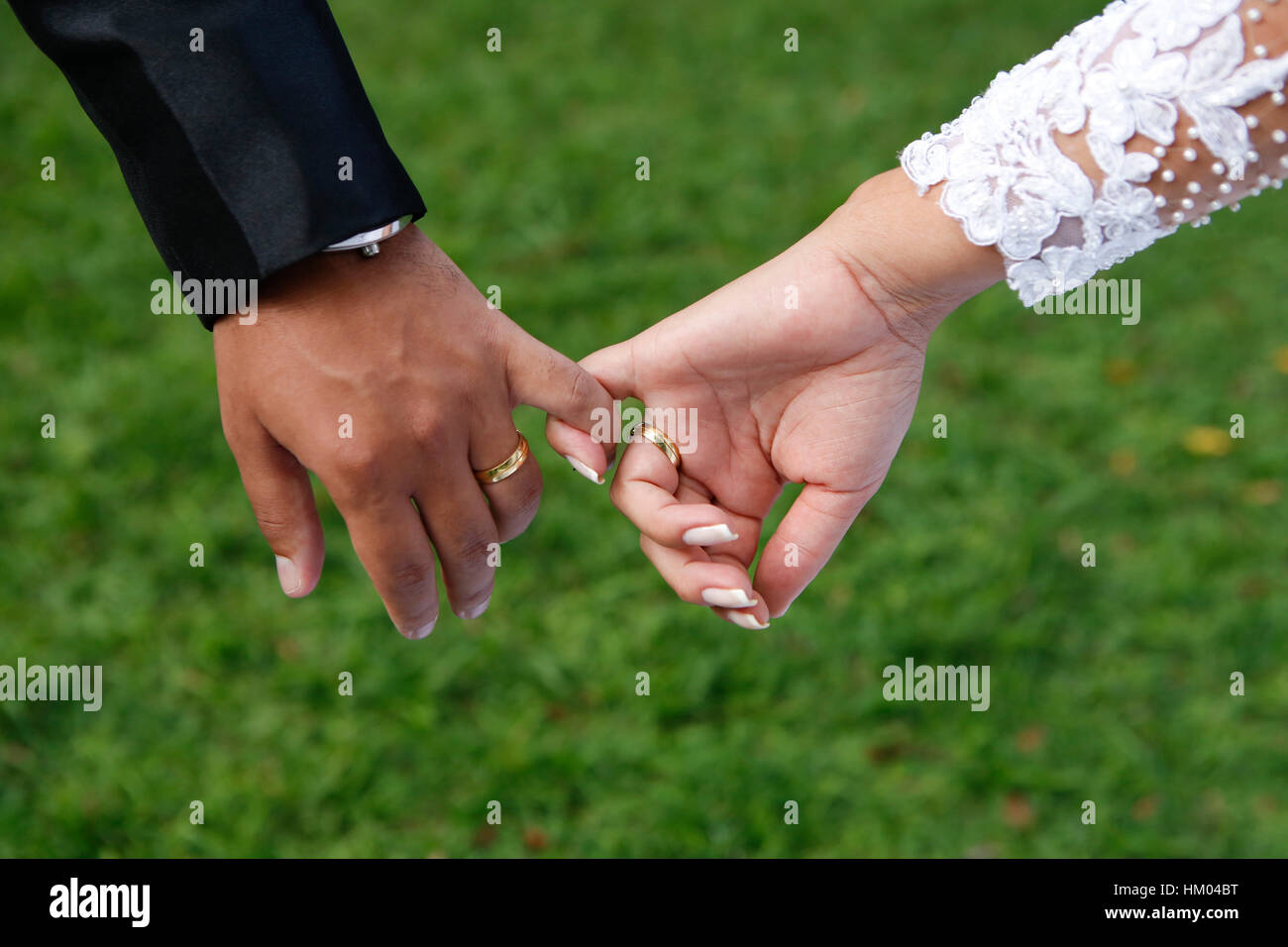 Married hands with fingers showing wedding rings Stock Photo
